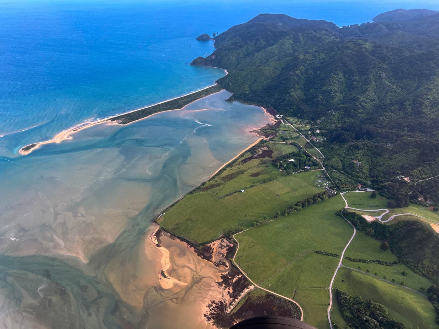 Aerial view over Golden Bay coastline, mountains and sea in New Zealand